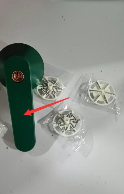 USB Rechargeable Lint Remover with replacement blades on a white surface.