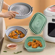 Air Fryer Silicone Pot in gray and green displayed with food, showcasing collapsible design and compatibility with air fryers.